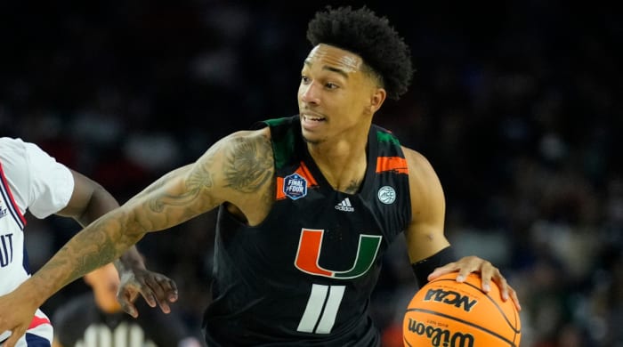 Miami guard Jordan Miller drives the ball